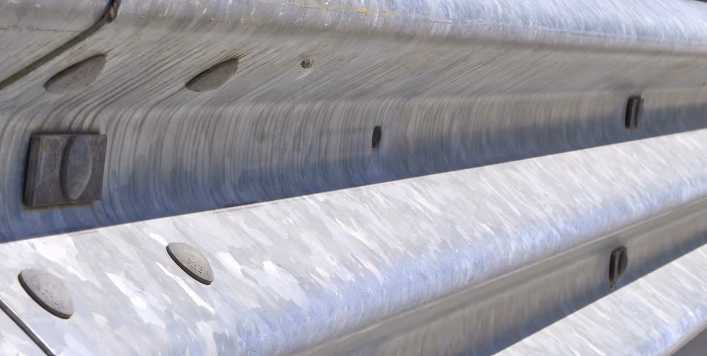 Galvanized steel guardrail beams for highway safety infrastructure and commercial hauling services