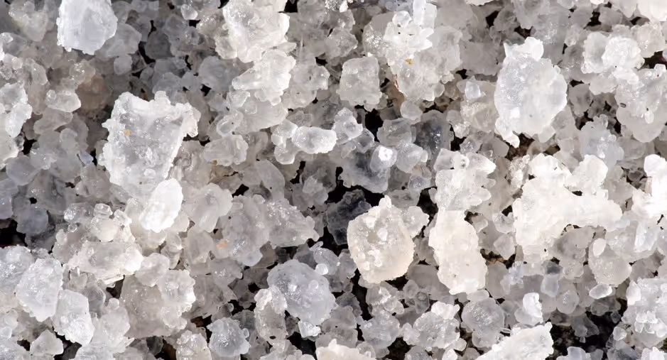 White rock salt crystals for commercial road deicing and winter maintenance material hauling services