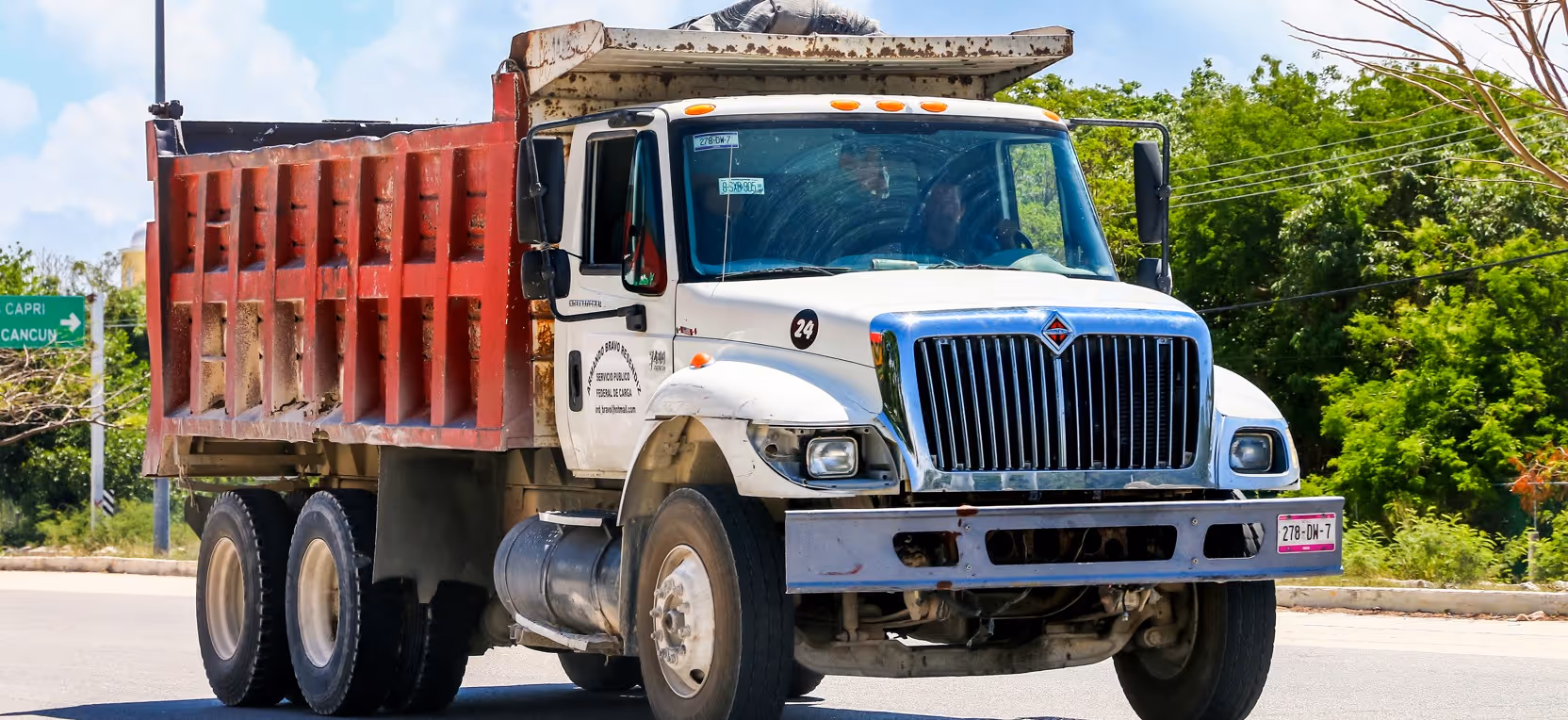White tandem axle dump truck for commercial construction hauling and medium-scale material transport services