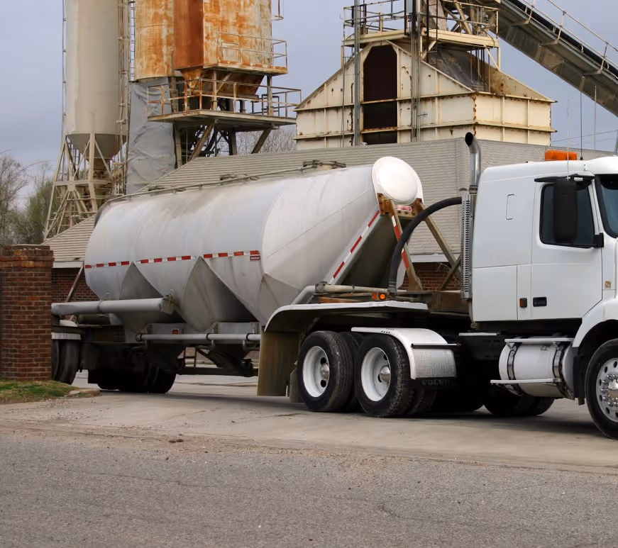 White pneumatic bulk tanker truck for dry material transport and commercial bulk hauling services