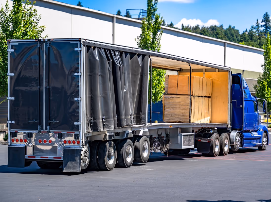 Blue truck with curtain-sided conestoga trailer for flexible commercial freight and cargo transportation services