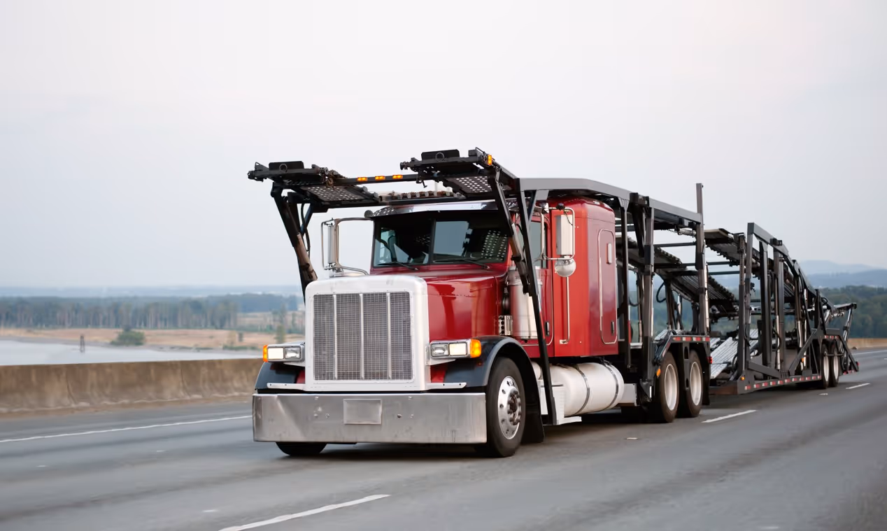 Red car hauler truck for vehicle transport and commercial auto delivery services