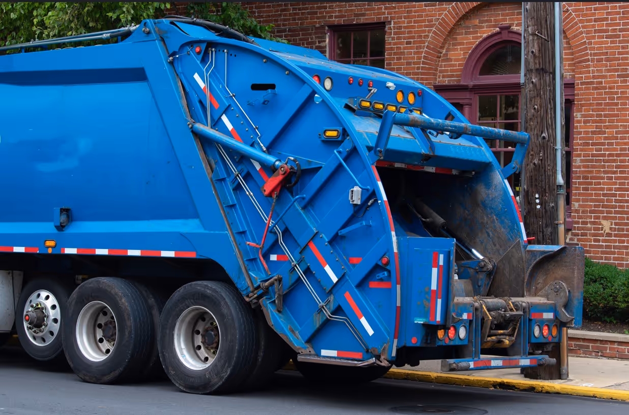 Blue garbage truck for commercial waste collection and municipal solid waste management services