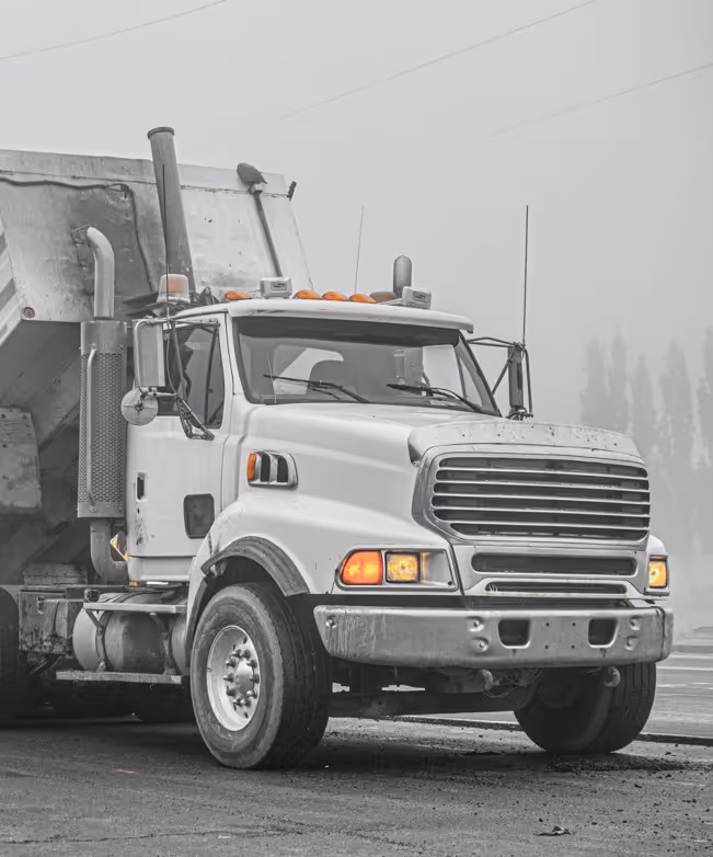 White winter emergency truck with flashing lights in harsh weather in Springfield, Massachusetts