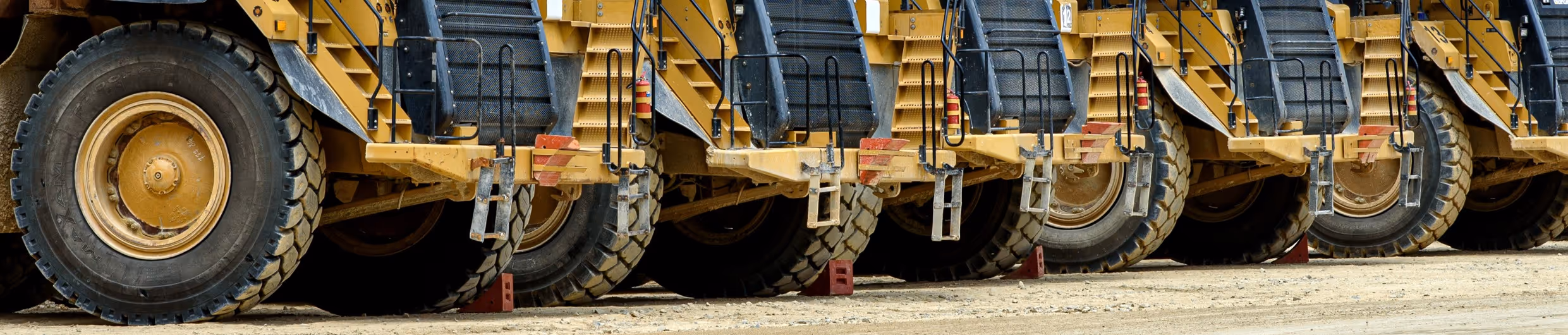 Yellow heavy equipment and machinery lineup for specialized hauling in Springfield, Massachusetts