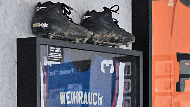 Tony's Restaurant Hancock Sports Hall of Fame memorabilia. Cleats and Blue Jersey.