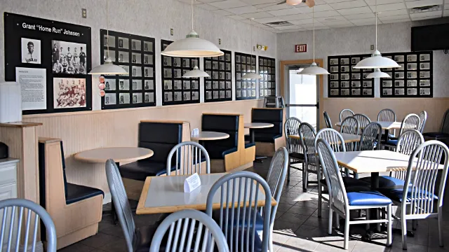 Tony's Restaurant Hancock Sports Hall of Fame memorabilia. Wide shot of seating area.