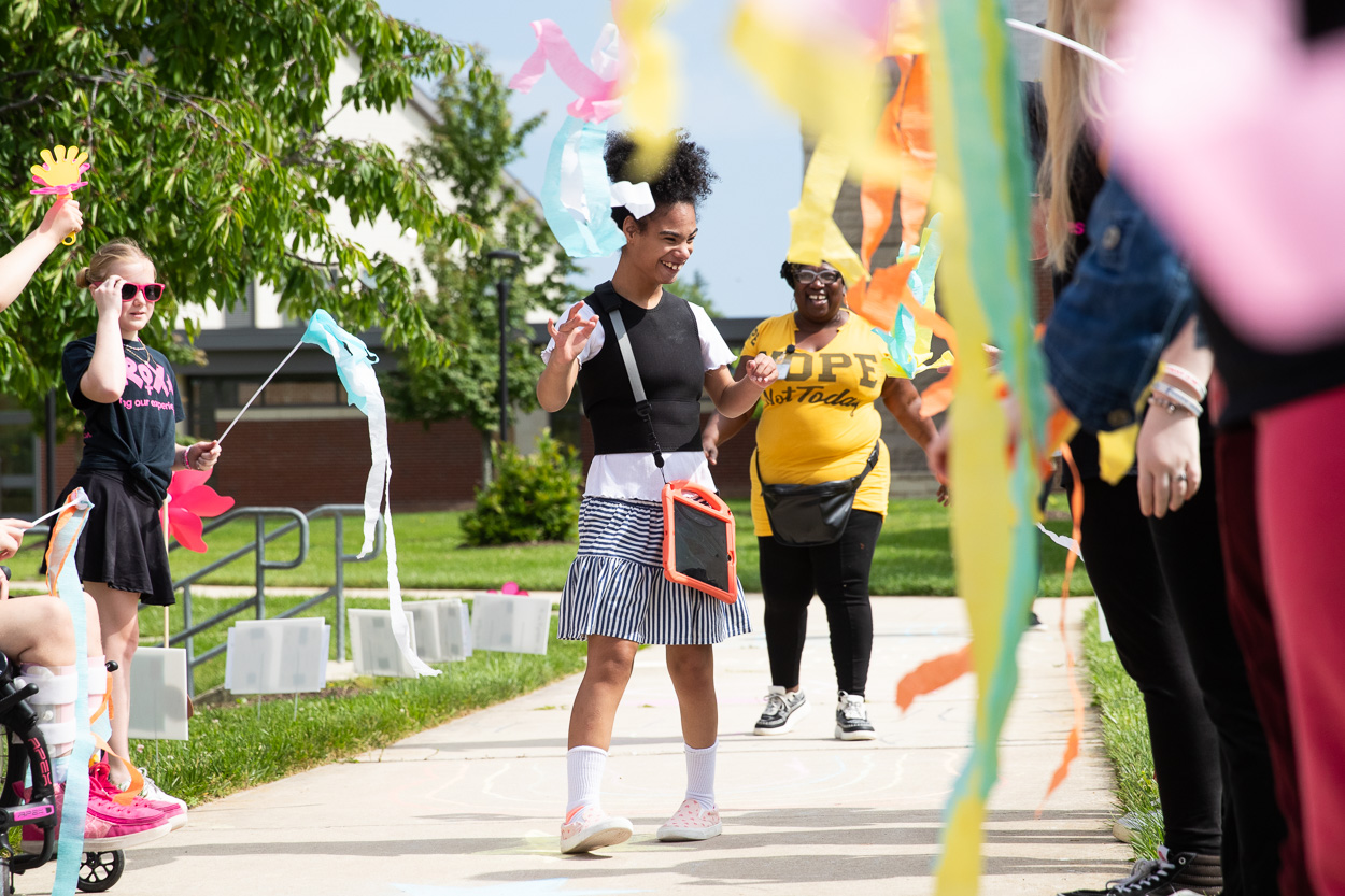 A Student at the Maryland School for the Blind walking through a student pathway being celebrated