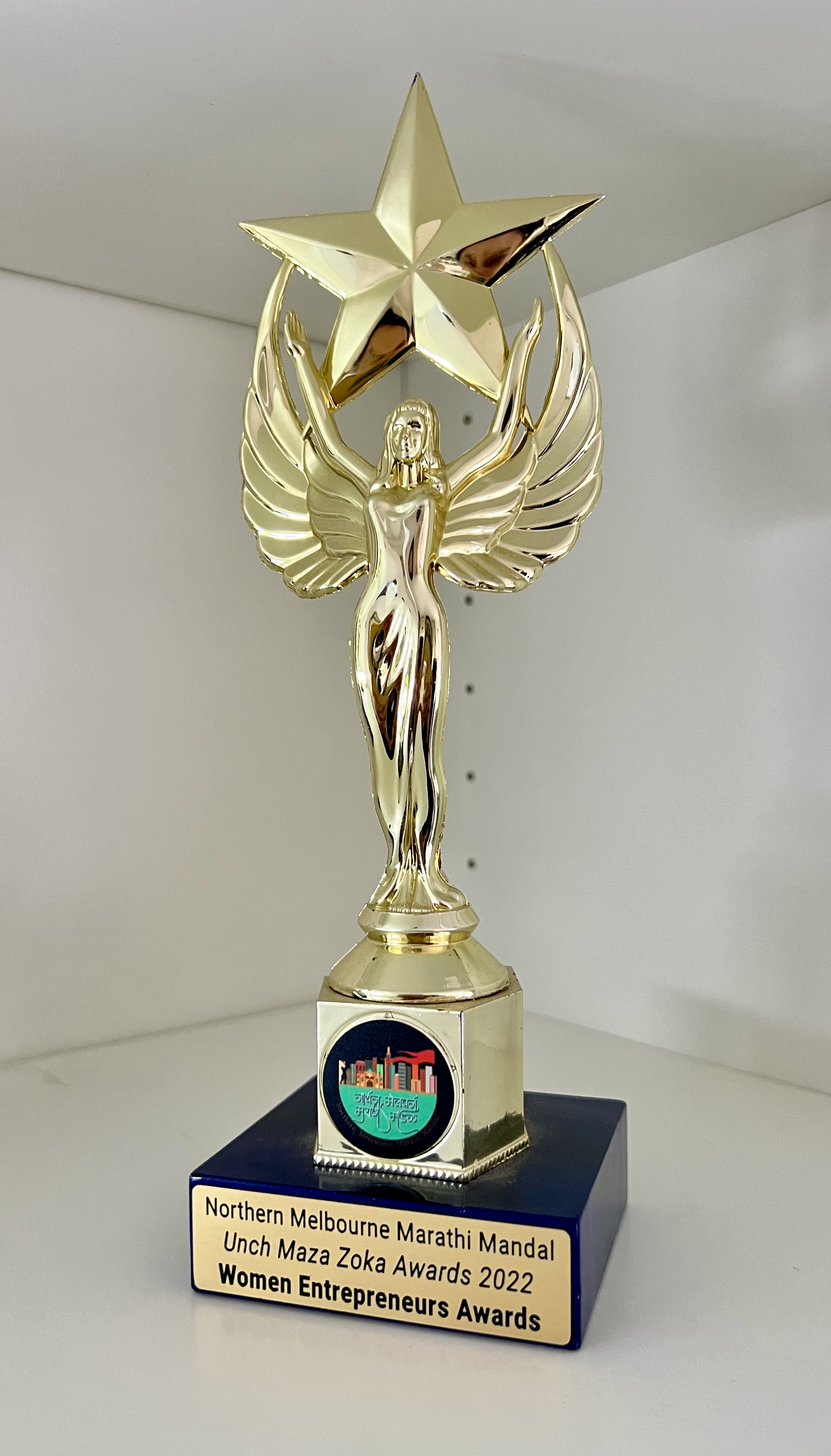 Golden trophy with winged female figure holding a star, labeled Northern Melbourne Marathi Mandal Unch Maza Zoka Awards 2022 Women Entrepreneurs Awards.