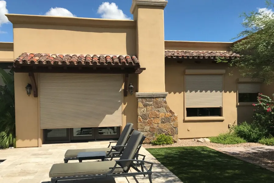 Rolling shutters covering windows and glass doors