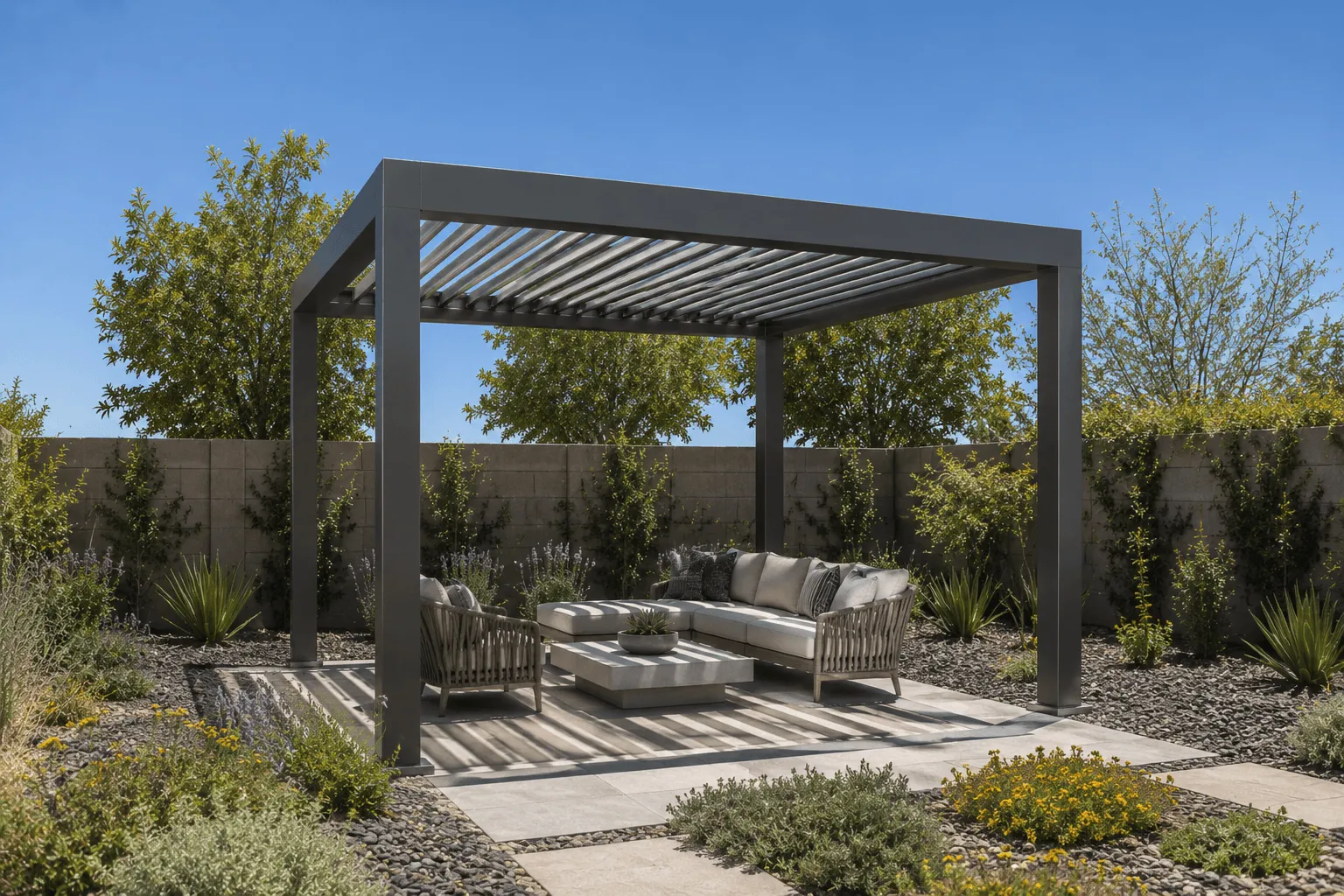 Freestanding louvered pergola shading a patio sofa and lounge chairs in a desert backyard
