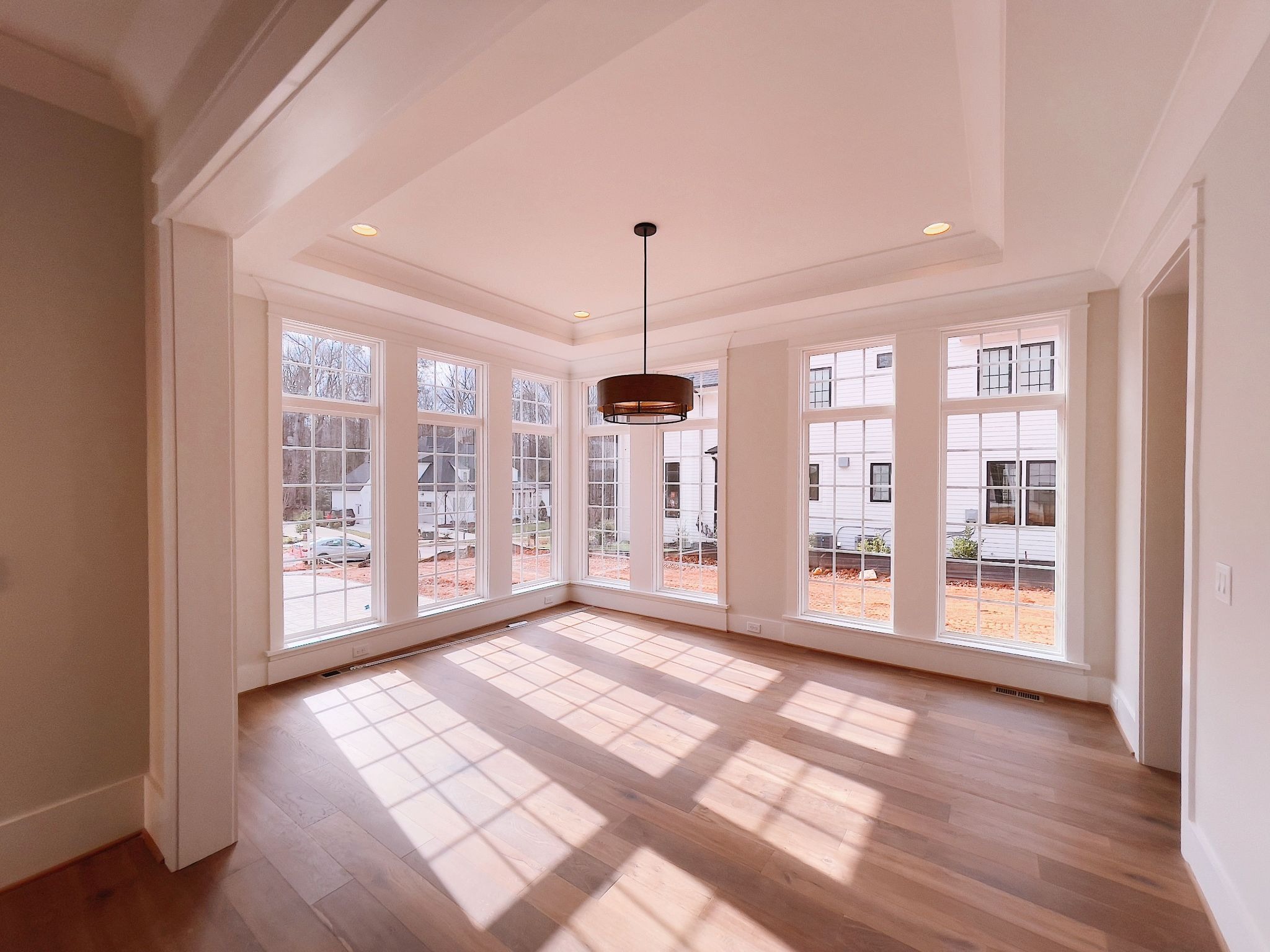 Direct sunlight entering a room through large residential windows