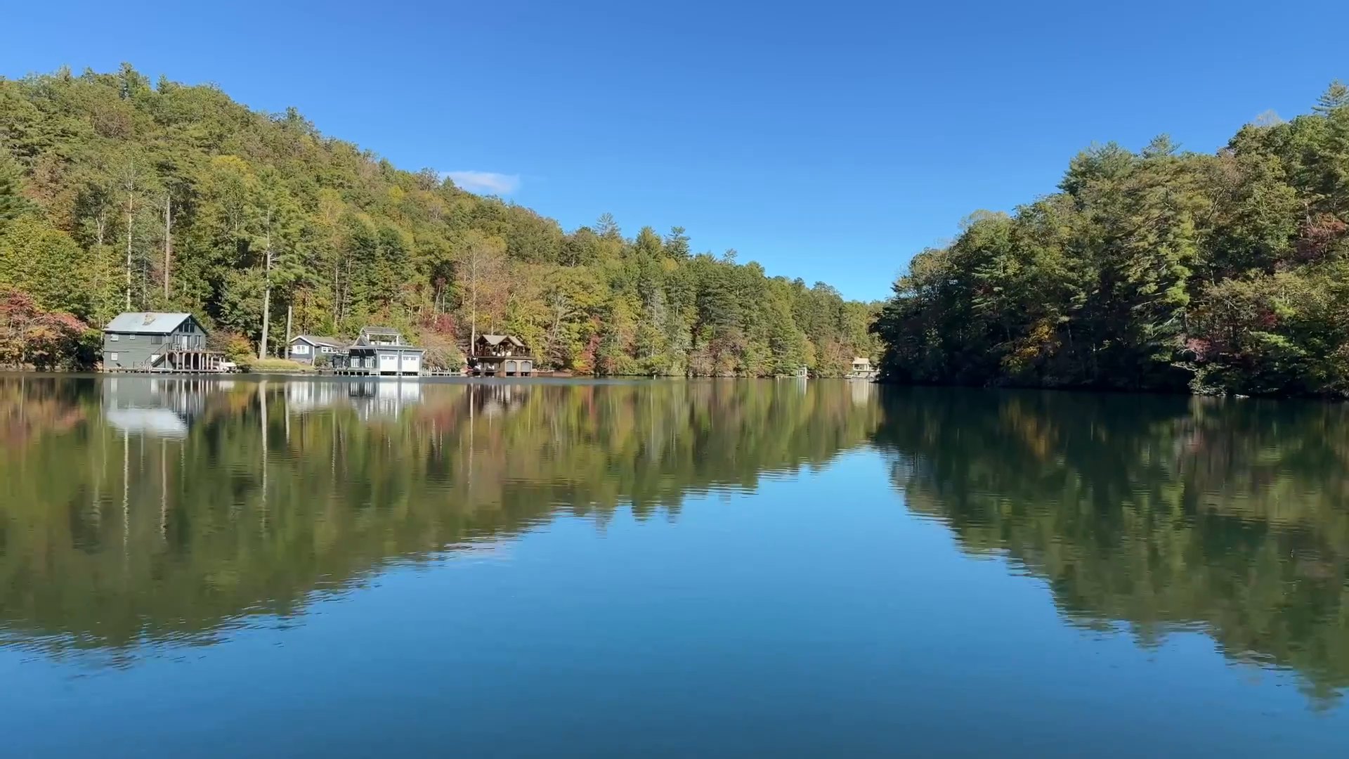 Early fall color reflected in the still water of Lake Burton
