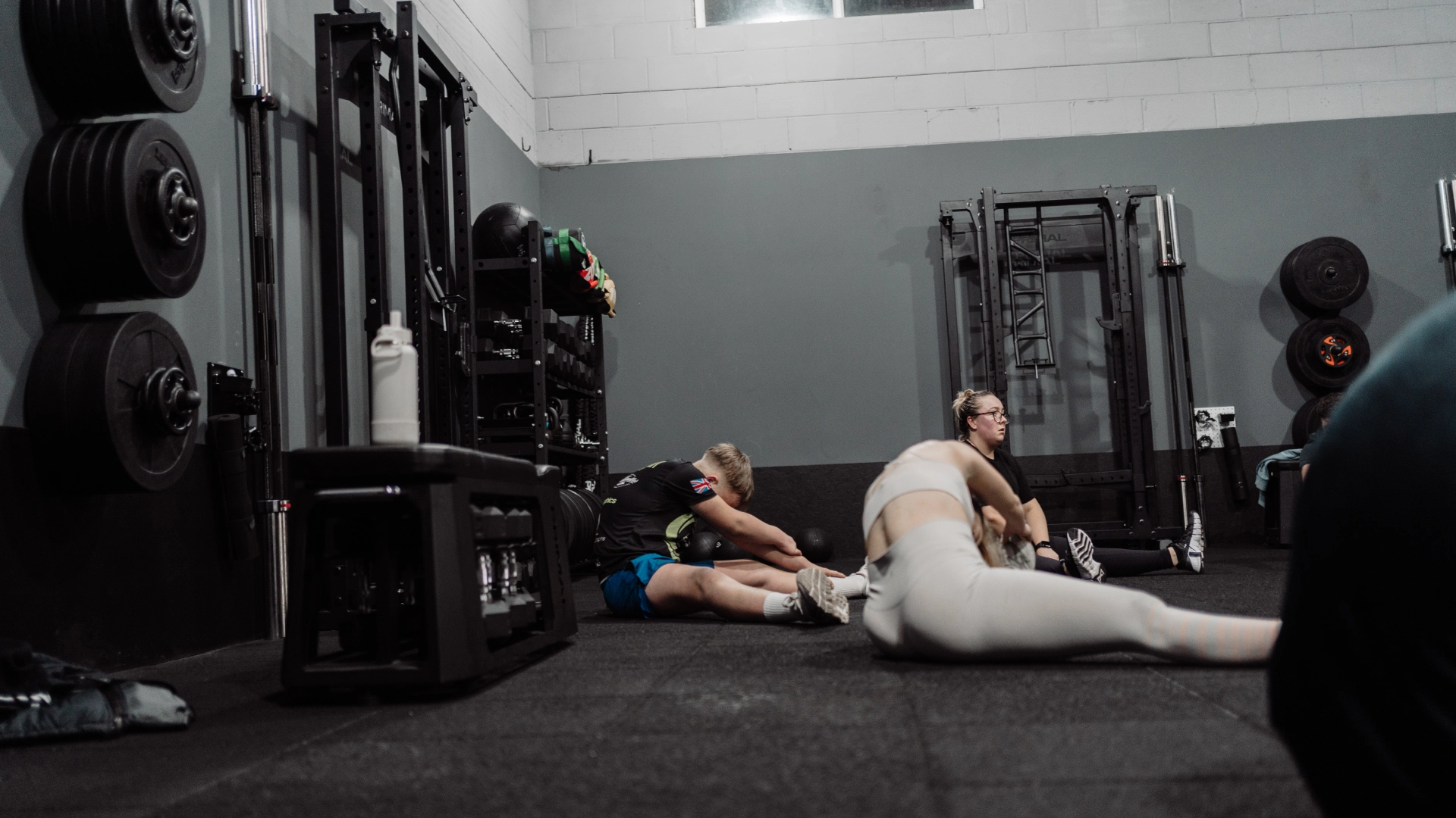 People gathered on the gym floor at Unity Personal Training in Grays, ENG, involved in a collaborative fitness exercise.
