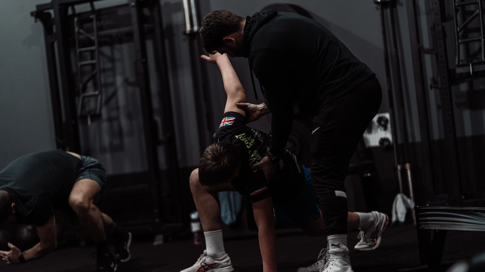 A man performs squats in a gym, showcasing strength training at Unity Personal Training in Grays, ENG.