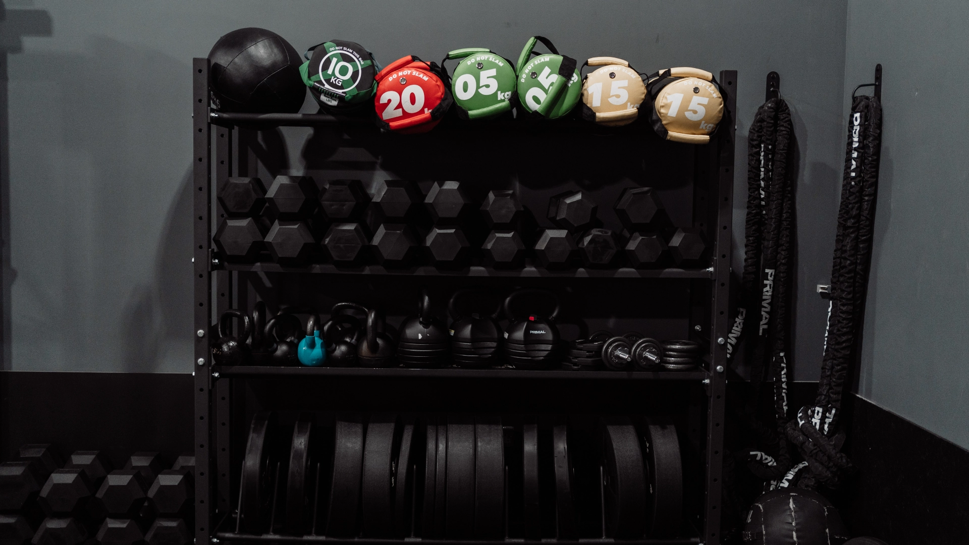A black rack displaying various weights and dumbbells at Unity Personal Training in Grays, ENG.