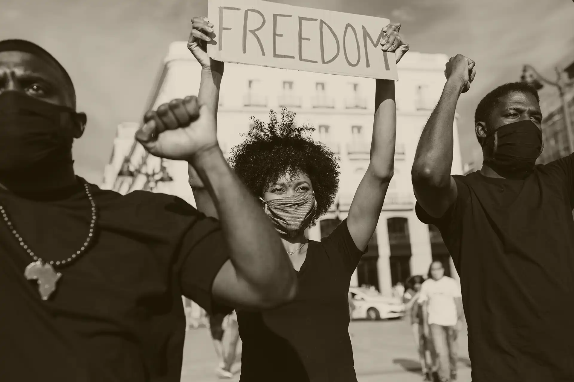 Black protesters holding up a sign that says freedom.