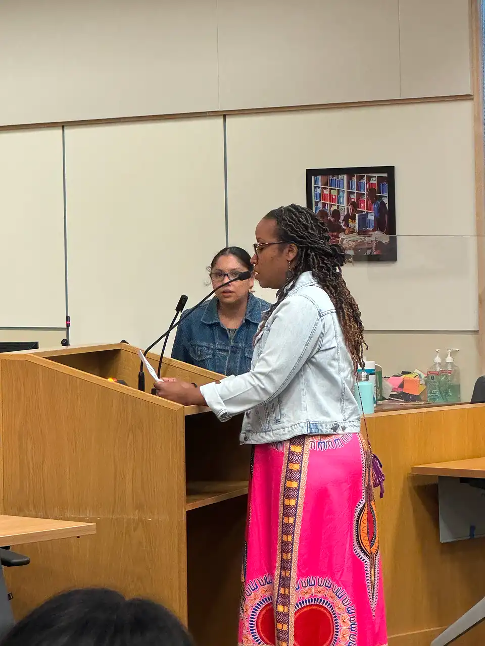 A speaker at a community event for educational justice