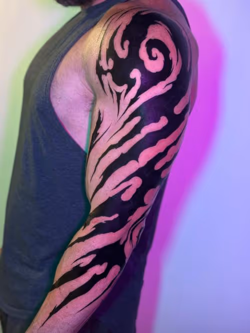 Arm with bold black tribal sleeve design