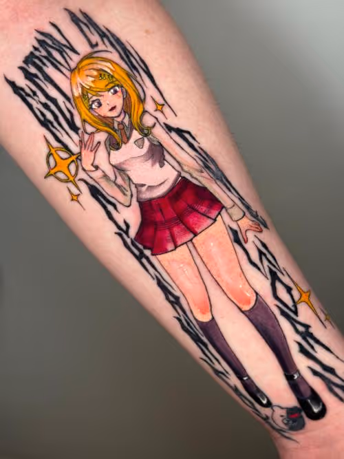 Anime character tattoo on forearm with blonde hair, red skirt, knee-high socks, sparkles and jagged black accents.