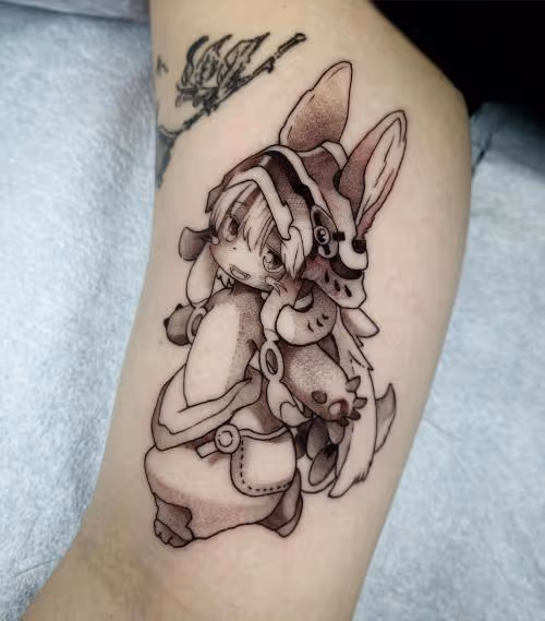 Black and gray tattoo of Nanachi from Made in Abyss on an arm
