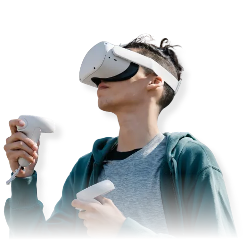 Person wearing a virtual reality headset and holding VR controllers while interacting with a virtual environment.