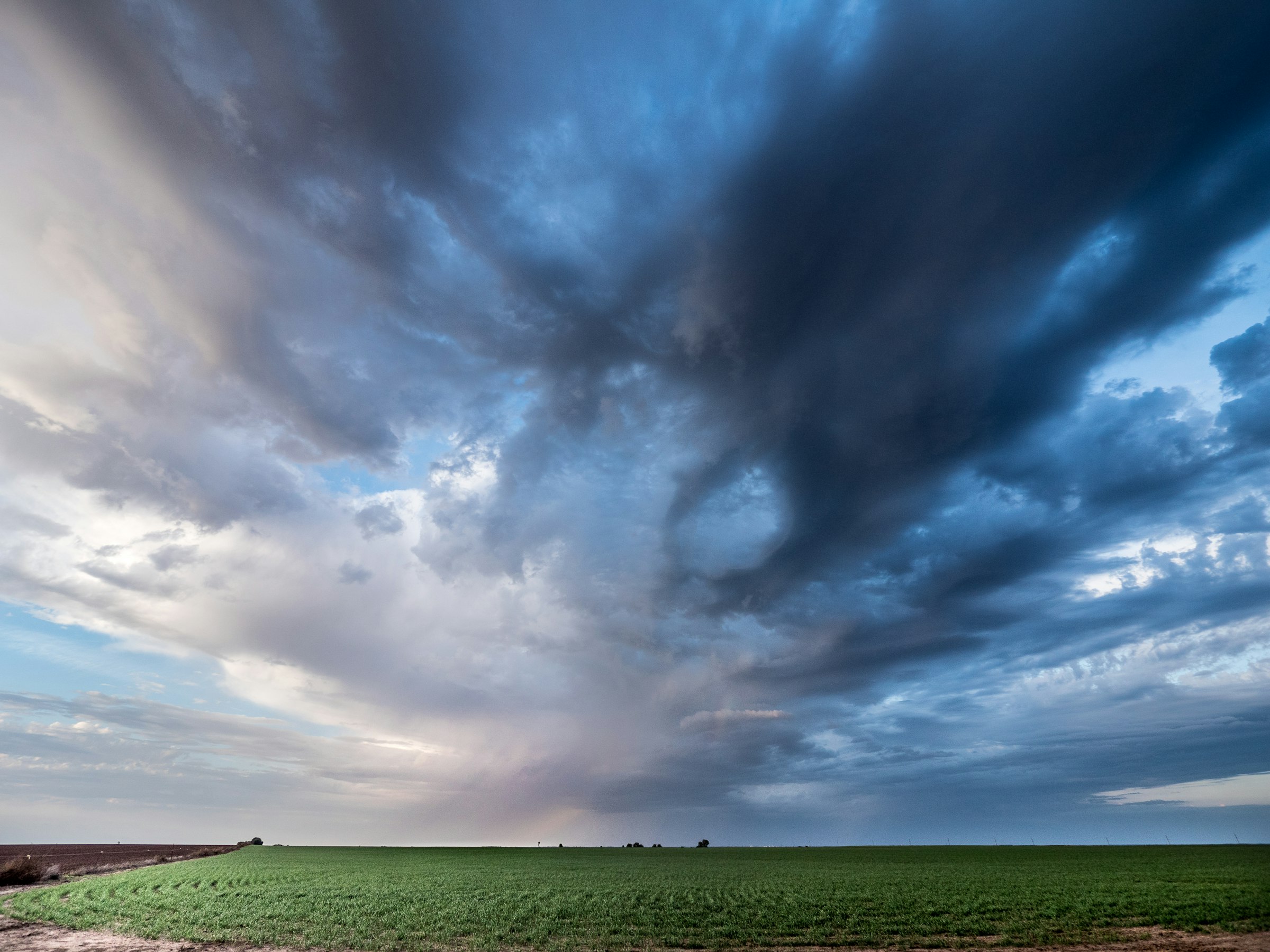 Storm clouds over green prairie in northern Oklahoma, the region around Enid