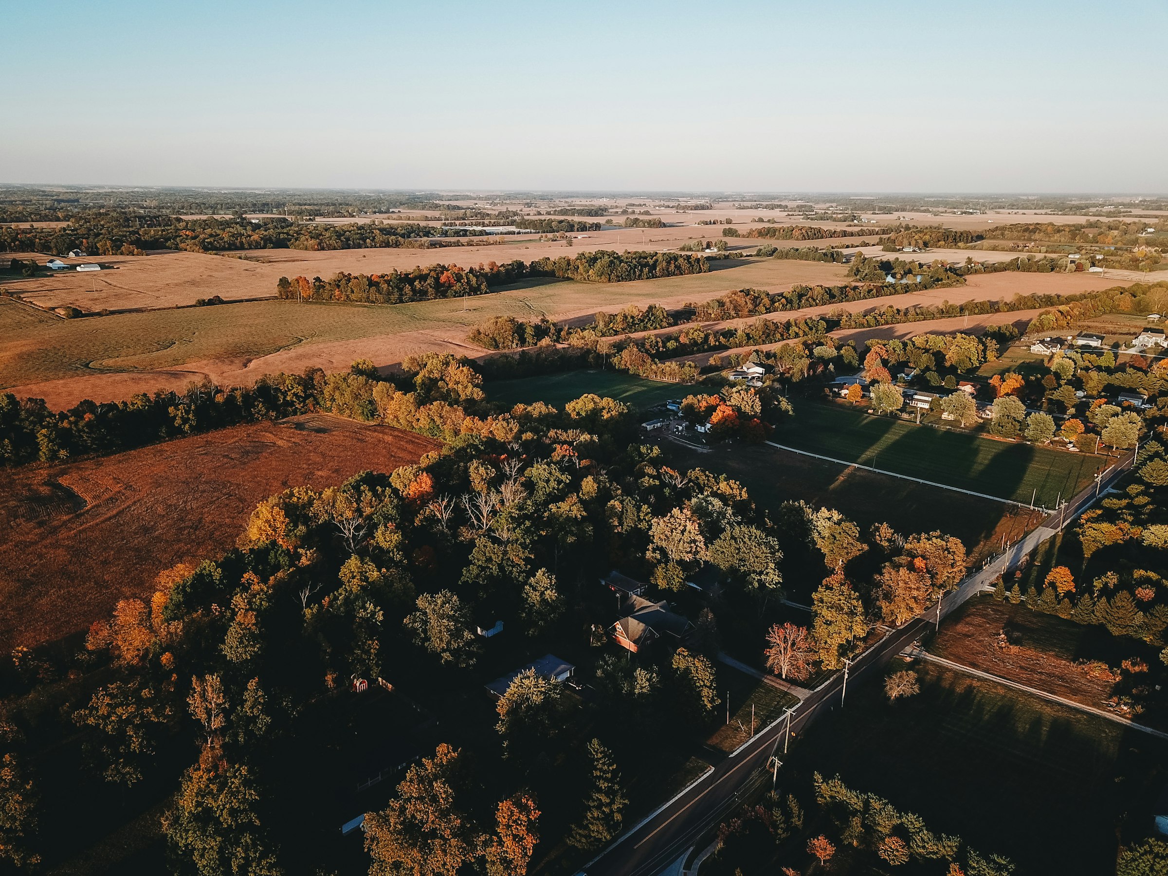 Aerial view of autumn trees and harvested fields near Noblesville, Indiana