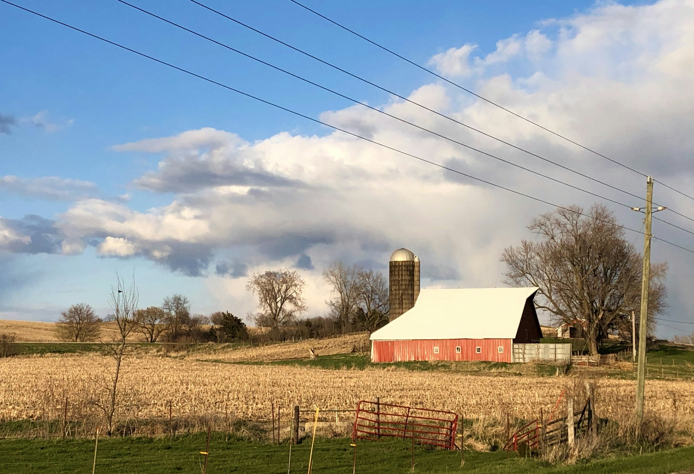 Iowa farm with red barn and silo in spring