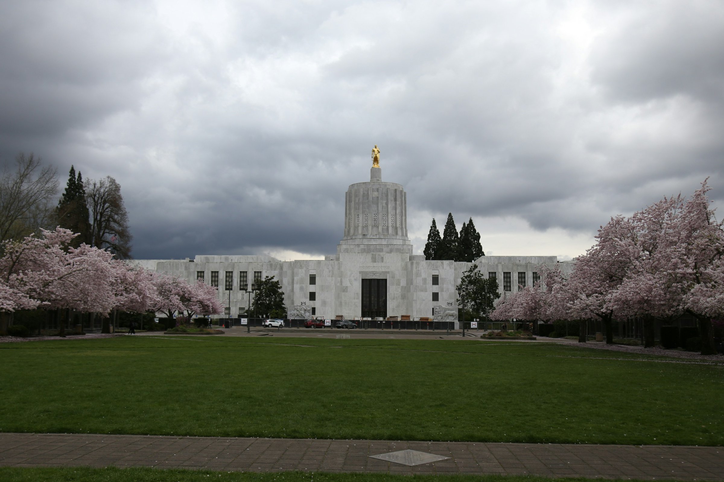 Oregon State Capitol in Salem framed by blooming cherry trees