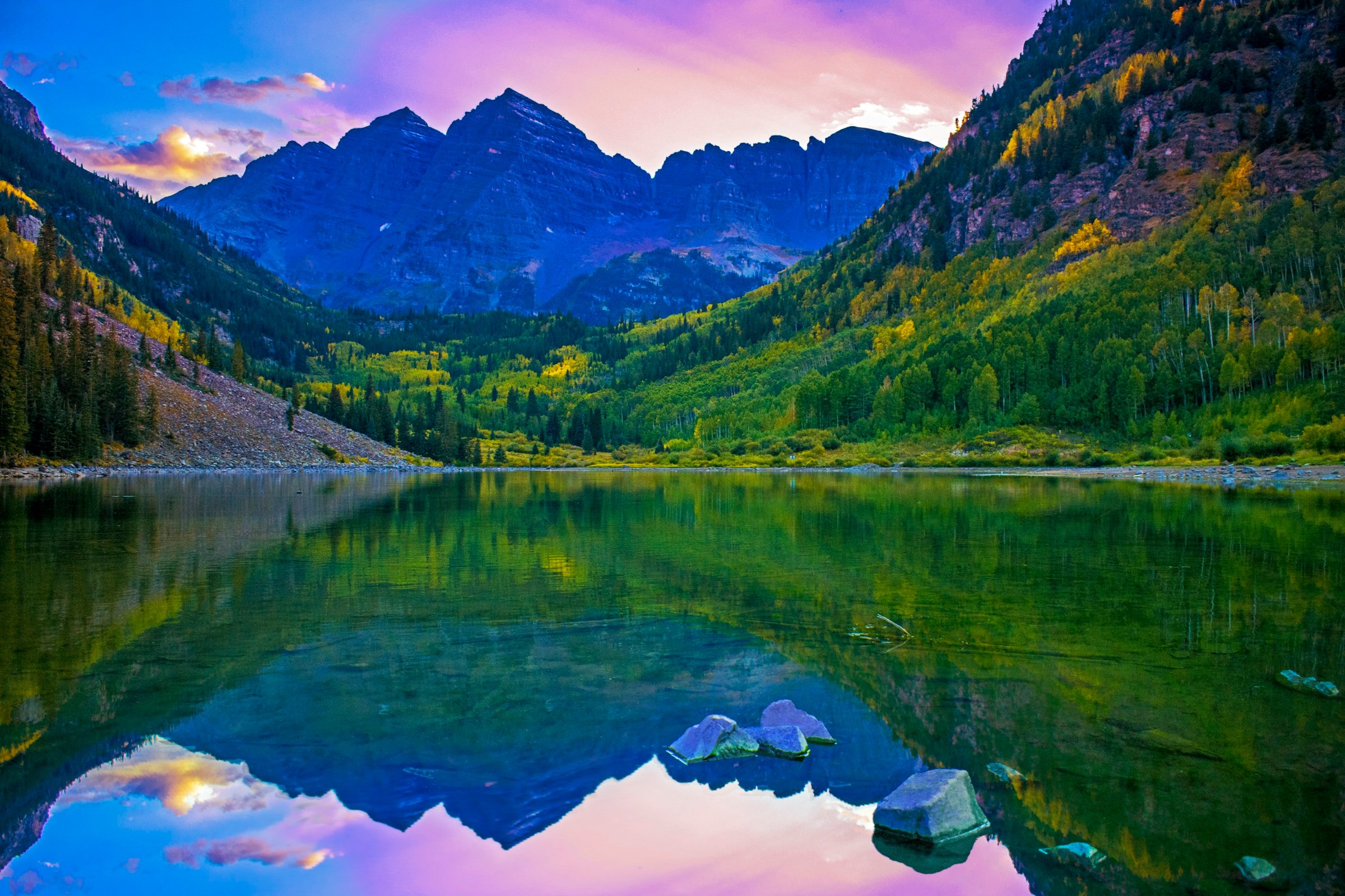 Maroon Bells peaks reflected in Maroon Lake at sunset in the Colorado Rocky Mountains