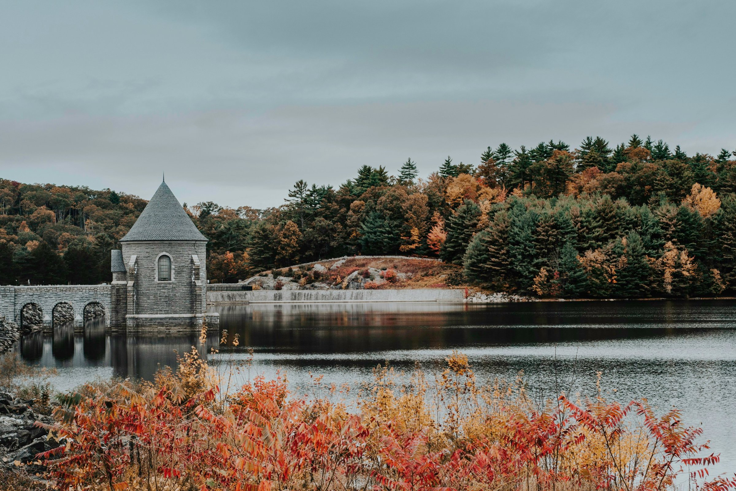 Saville Dam gatehouse and fall foliage on the Barkhamsted Reservoir in Connecticut