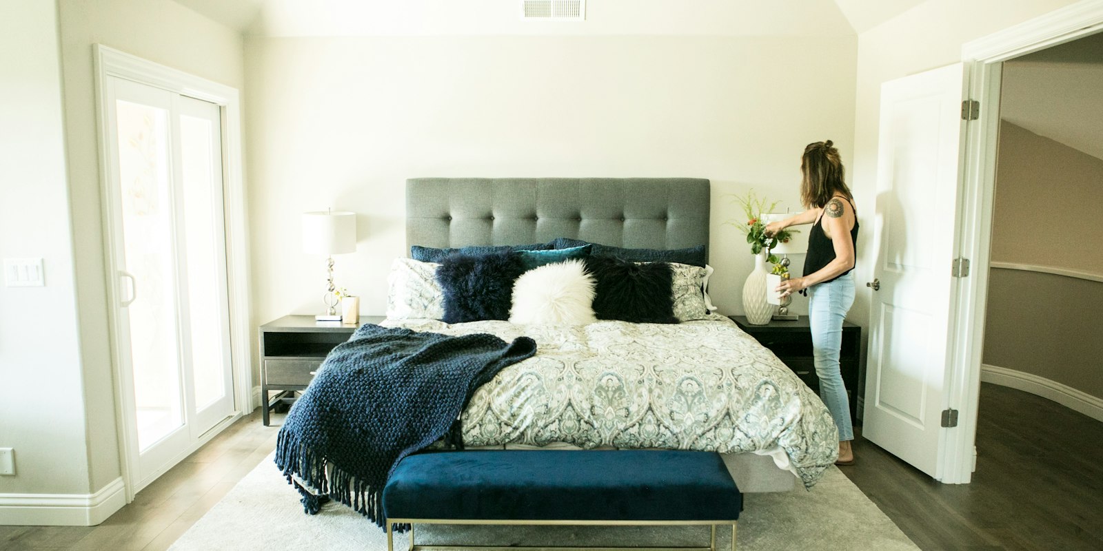 Short-term rental owner staging a guest bedroom, the kind of hands-on work that counts toward material participation