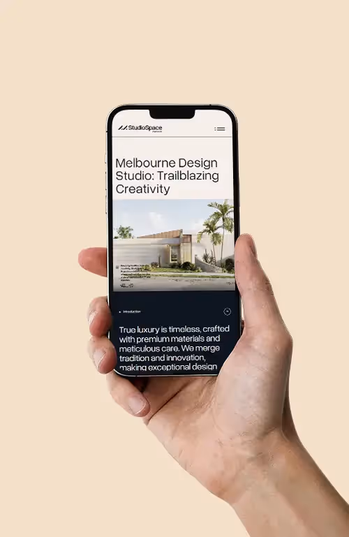 Mockup of a hand holding a phone that shows Studiospace's website