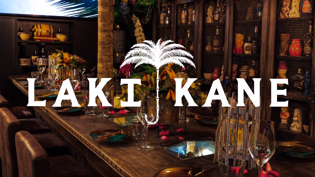 Cover showing the interior of Laki Kane, a high-end cocktail bar, with their logo overlayed on top.