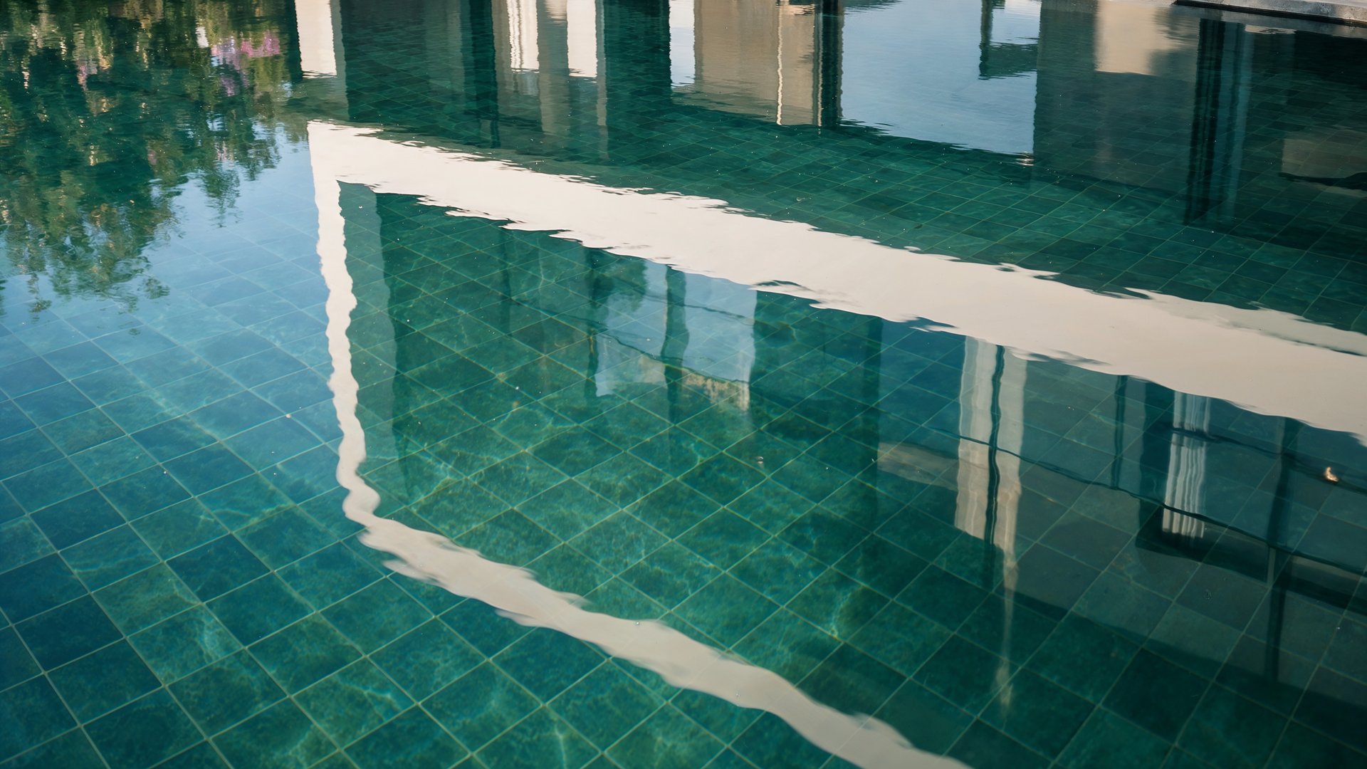 Villa reflected in the still water of the pool