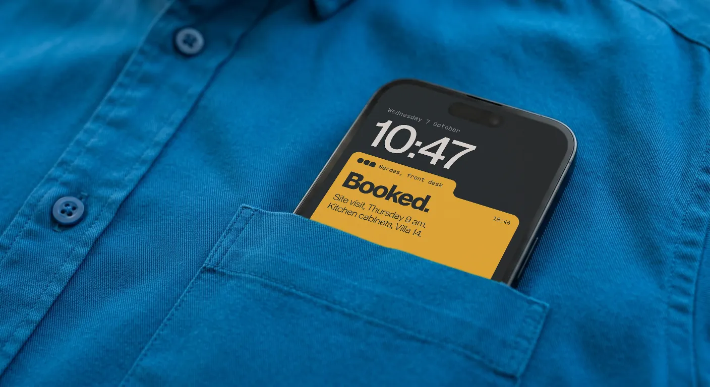 A phone in a blue shirt pocket, its lock screen reading Booked: a site visit on Thursday at 9 am