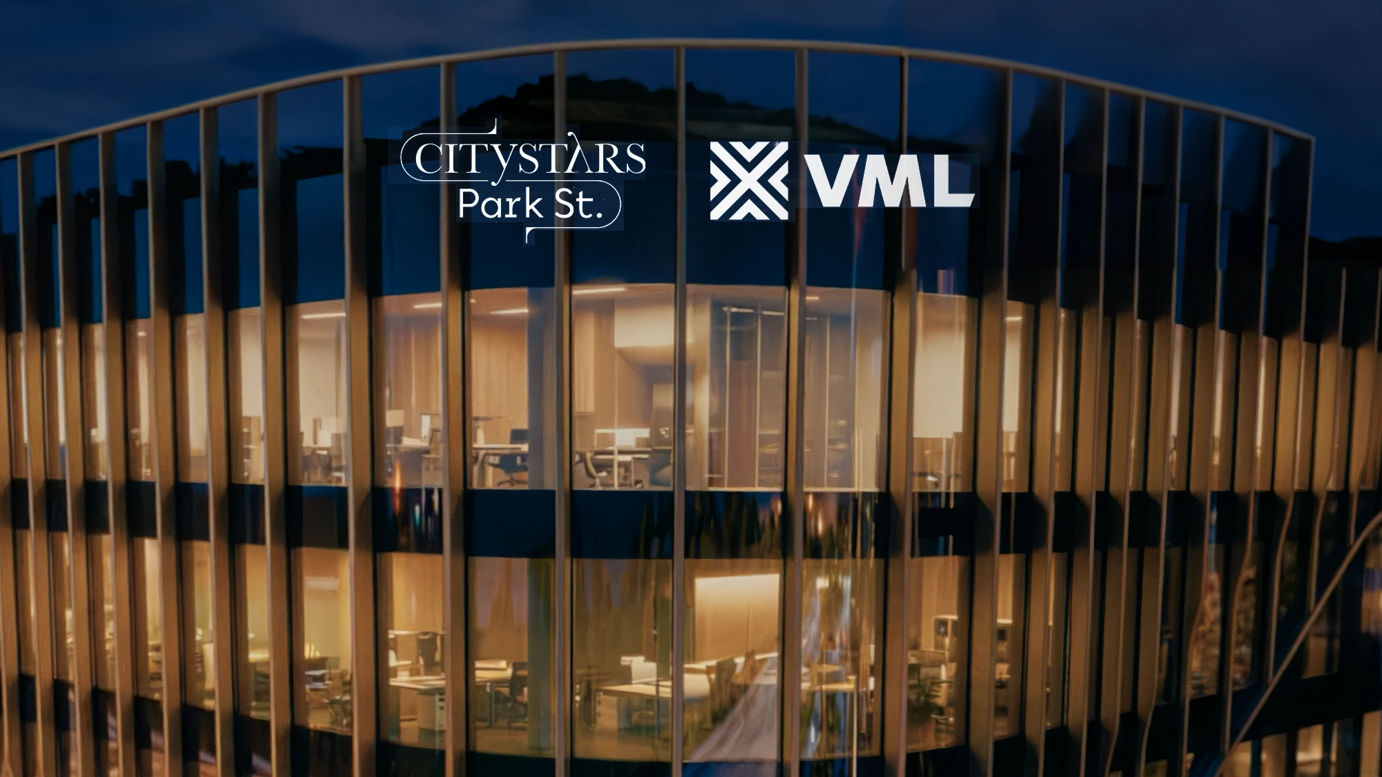 The ribbed glass facade of Citystars Park St. Offices at night with the Citystars and VML logos, from the AI film by iklipse