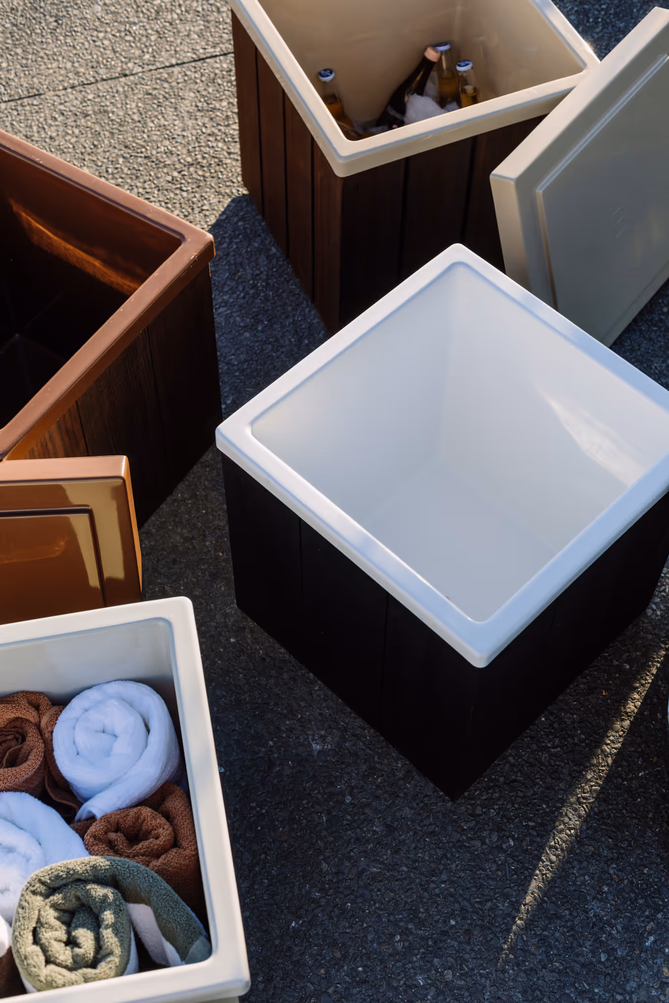Star Baths insulated storage boxes open to reveal drinks, towels and accessories — available in multiple colours and timber finishes