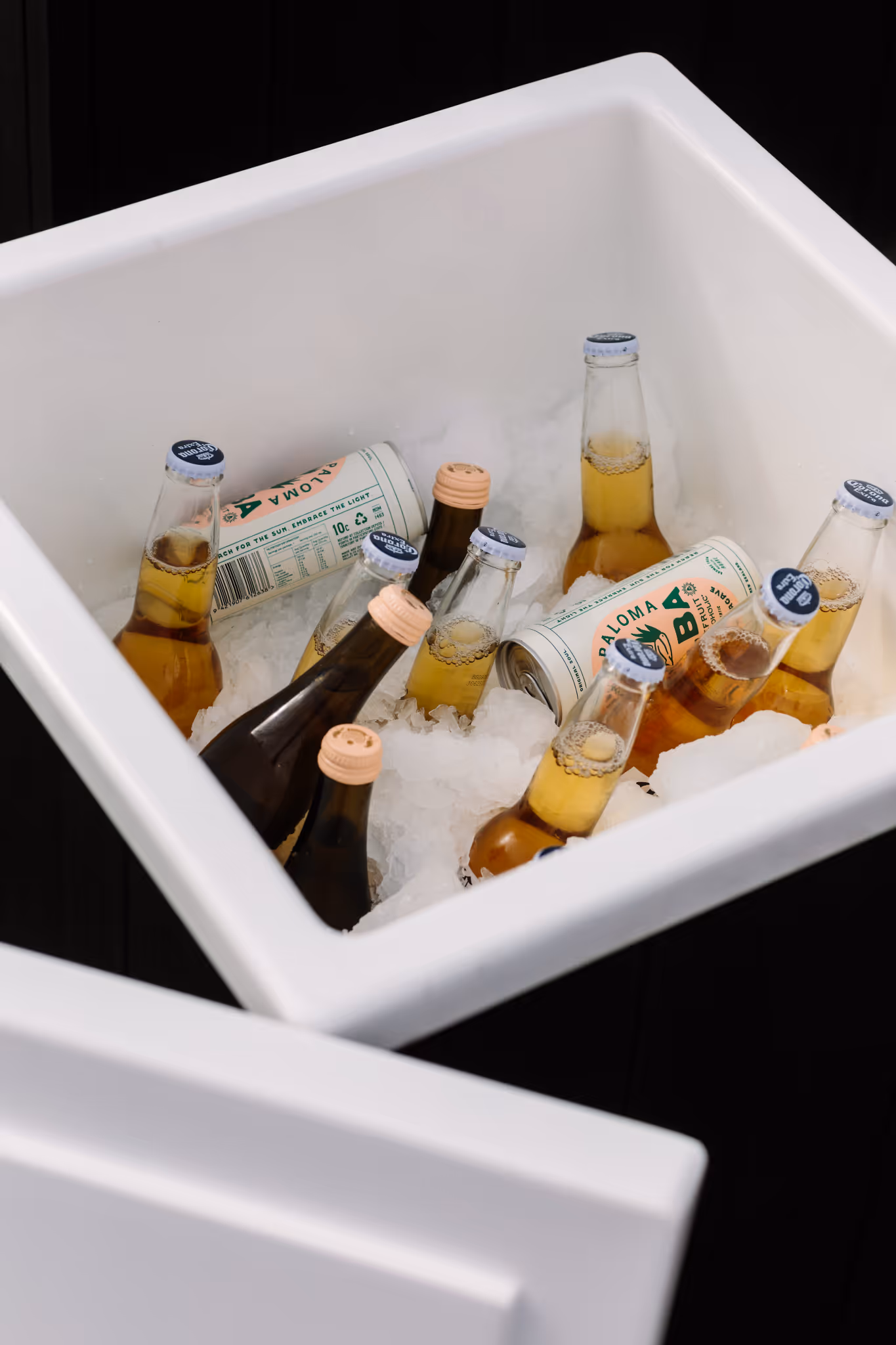 Interior of Star Baths insulated storage box filled with cold drinks and ice — dark timber exterior with white insulated inner liner