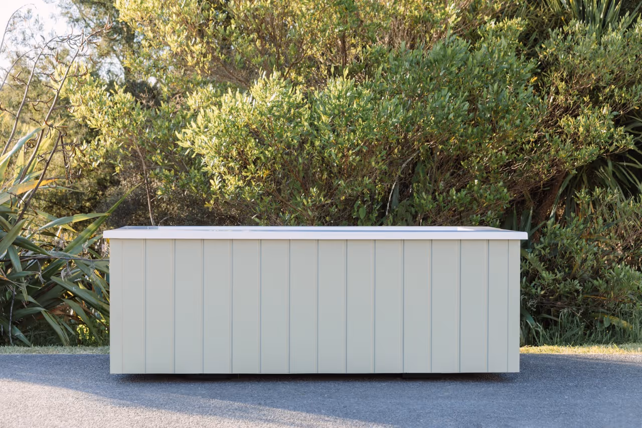 Star Baths Custom Clad outdoor bath with architectural painted cladding in sage green, Raglan New Zealand