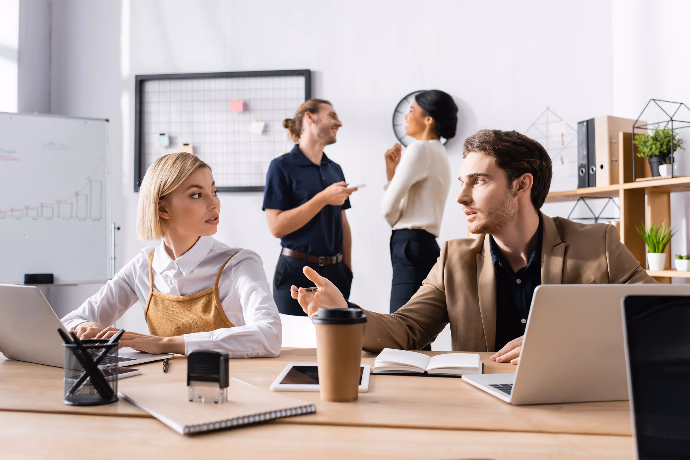 Small business environment with workers discussing opportunities.