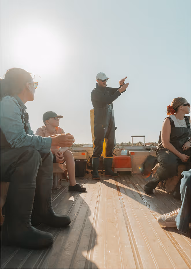 A tour guide on the boat pointing out different landmarks