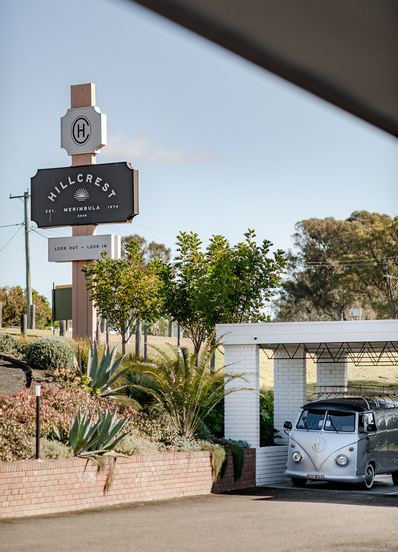 An exterior of a motel with a large sign