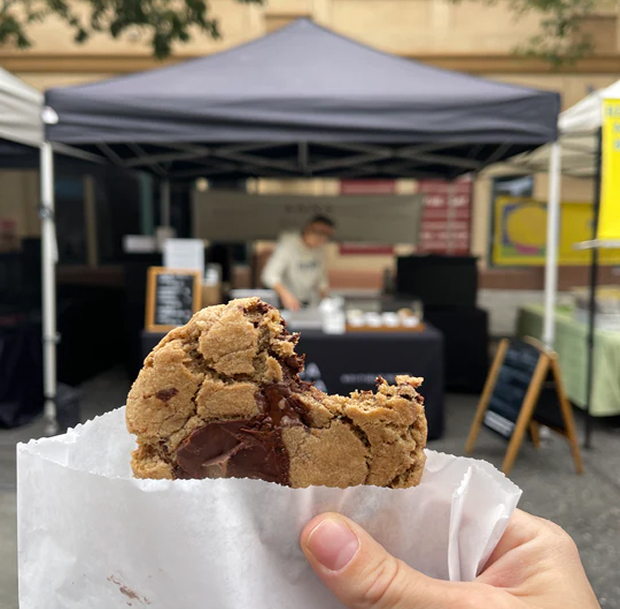 Cookie in front of an Anna Olivia farmers market setup