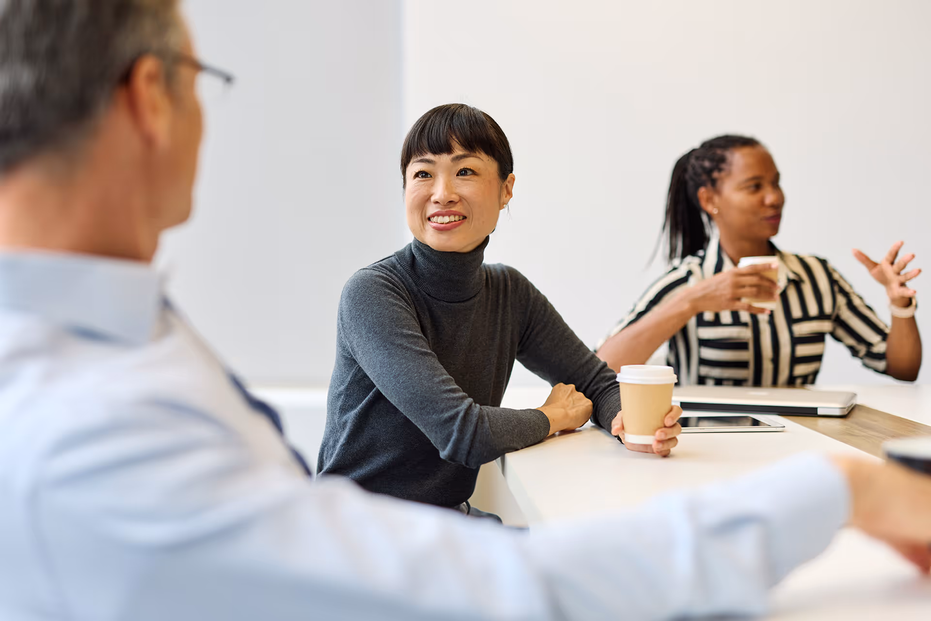A group of work colleagues in an open discussion about workplace wellbeing, burnout and performance.