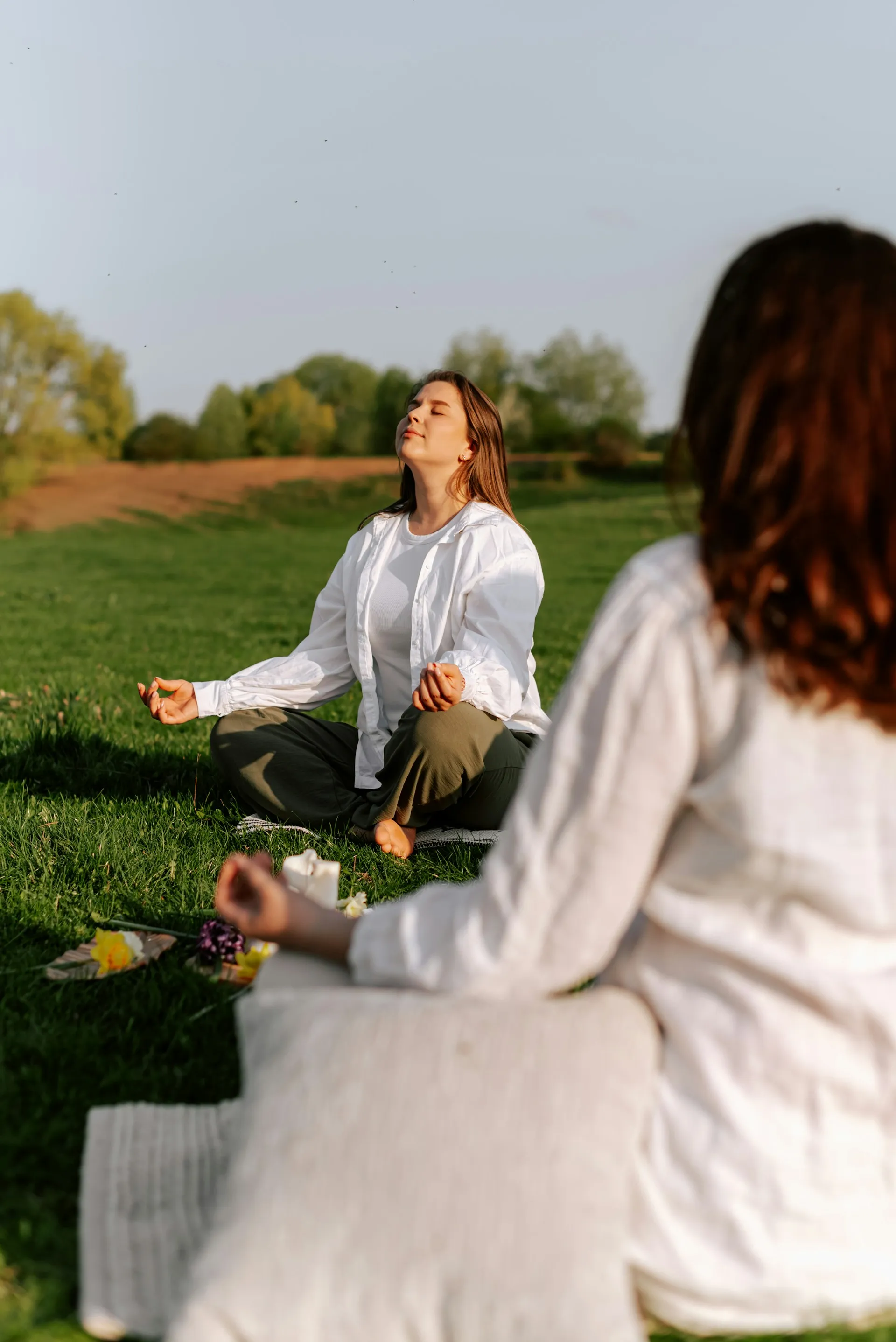 Two women sitting in a meditation circle at a retreat for women in high performing positions, held by the Balanced Elite.