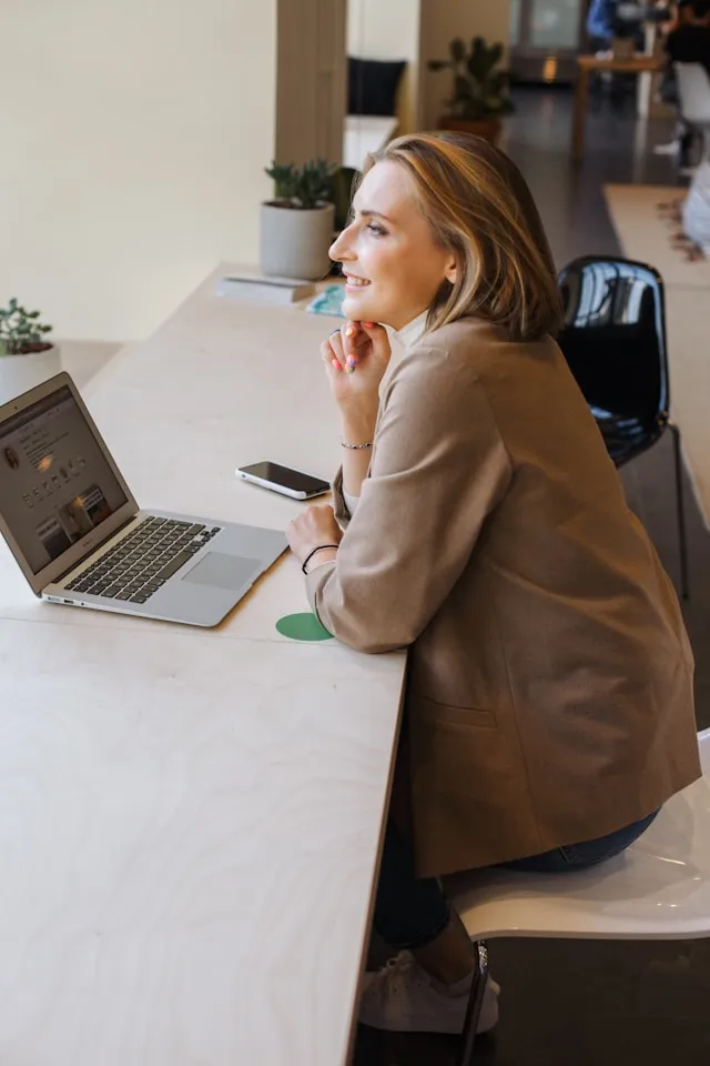 A woman sitting at her work desk talking on the phone about healthy Habits & Stress Resilience