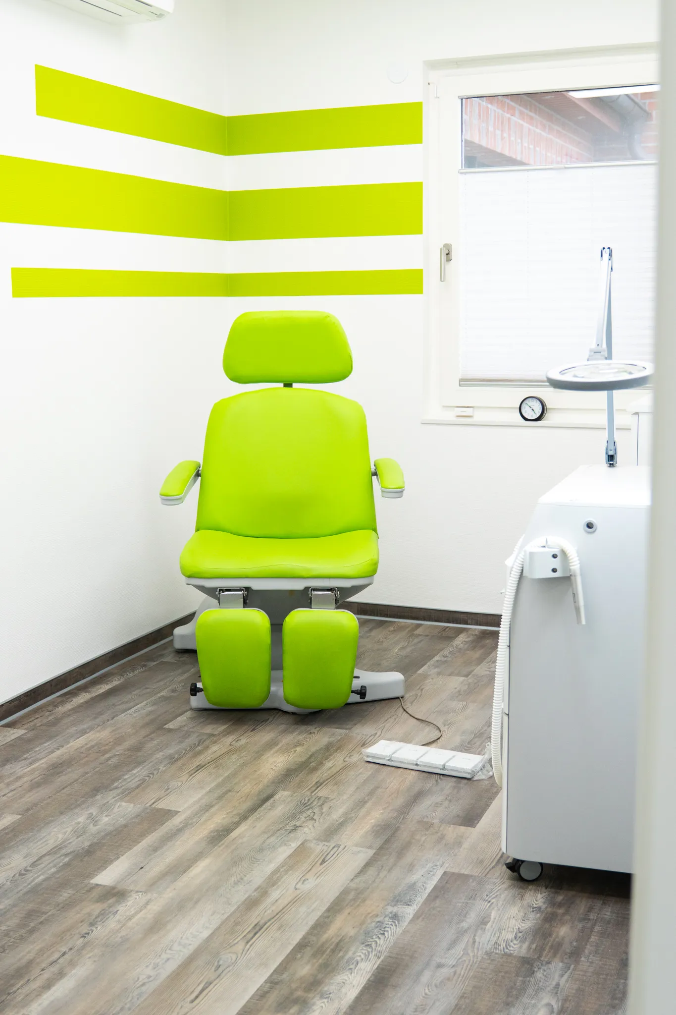 Ansicht einer Podologiepraxis mit einem grünen Behandlungsstuhl