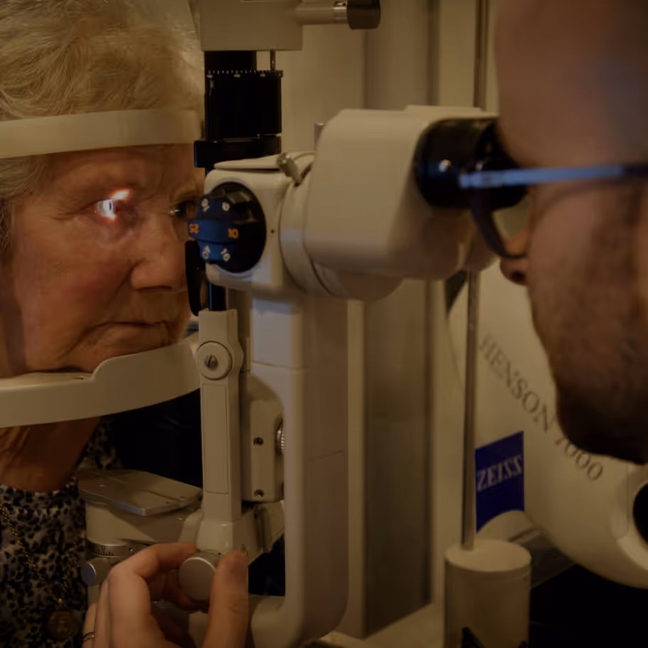 Patient receiving eye exam with professional medical equipment